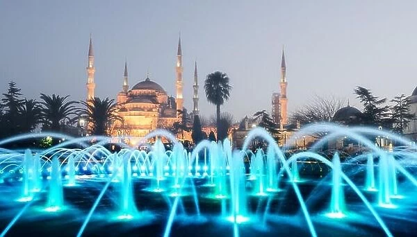 Fountain on Sultanahmet area in evening time. Multicolored streams against the background of the Blue mosque. Located place: Istambul, Turkey