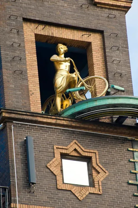 Framed Print : Fragment of building and statue of woman with bicycle in Copenhagen, Denmark Framed Print : Fragment of building and statue of woman with bicycle in Copenhagen, Denmark