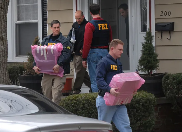 Framed Print : FRI Agents remove computers from a police detectives home after he was arrested for embezzlement Framed Print : FRI Agents remove computers from a police detectives home after he was arrested for embezzlement