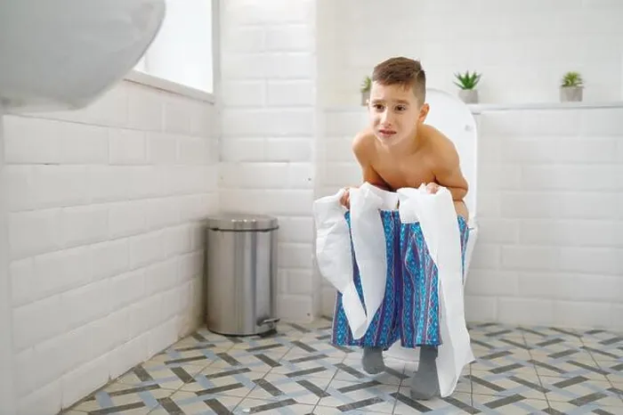Framed Print : Frowning little boy holding paper sitting on toilet and trying to poop. Child constipation, digestive problems Framed Print : Frowning little boy holding paper sitting on toilet and trying to poop. Child constipation, digestive problems