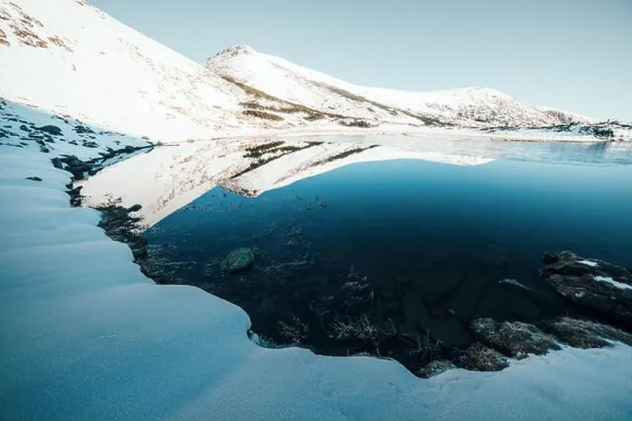 Framed Print : Frozen mountain lake with blue ice Framed Print : Frozen mountain lake with blue ice
