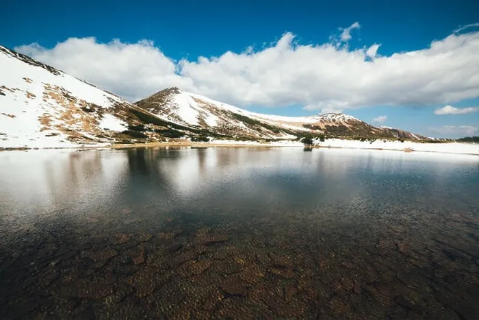 Framed Print : Frozen mountain lake with blue ice Framed Print : Frozen mountain lake with blue ice