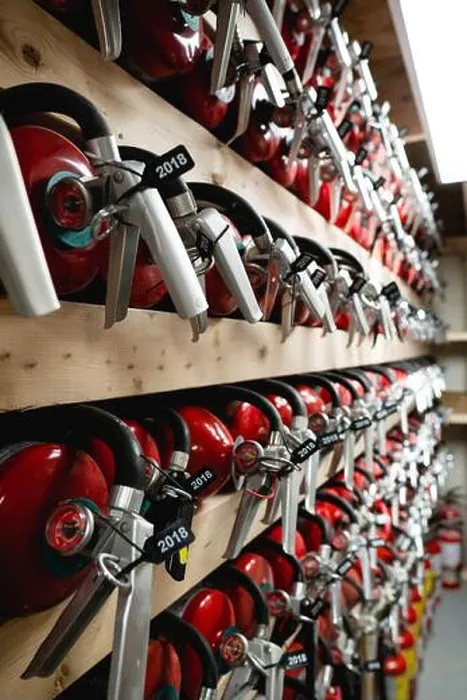 Framed Print : Fully equipped Fire extinguishers arranged and held in wood storage rack room Framed Print : Fully equipped Fire extinguishers arranged and held in wood storage rack room