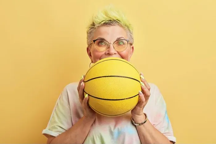 Framed Print : funny awsome old woman with dyed hair having fun with a basket ball Framed Print : funny awsome old woman with dyed hair having fun with a basket ball