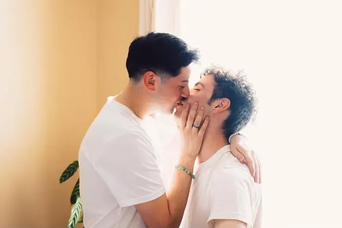 Framed Print : Gay couple romantically kissing on the mouth, in the living room. LGBT relationship and routine Framed Print : Gay couple romantically kissing on the mouth, in the living room. LGBT relationship and routine