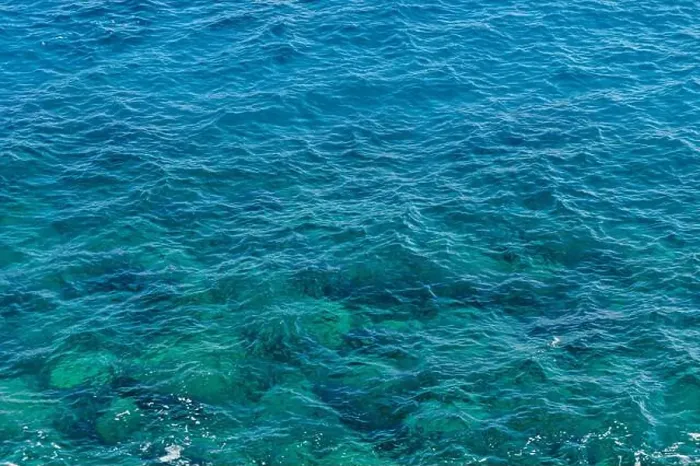 Framed Print : Gentle waves lapping against each other, reflecting sunlight in varying shades of blue and green Framed Print : Gentle waves lapping against each other, reflecting sunlight in varying shades of blue and green