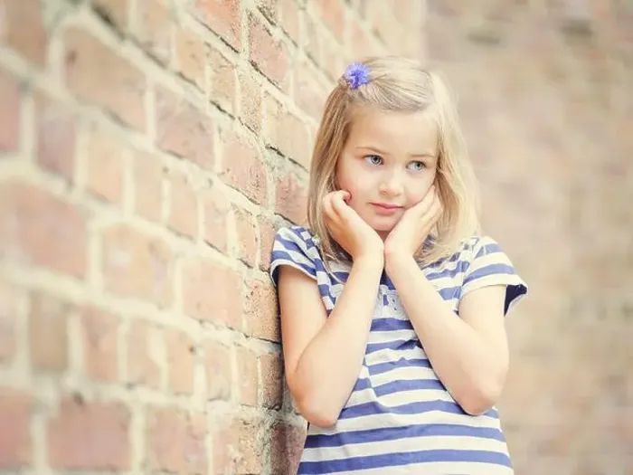 Framed Print : Girl, 10 years, leans against a wall, shy look, Portrait, Germany Framed Print : Girl, 10 years, leans against a wall, shy look, Portrait, Germany