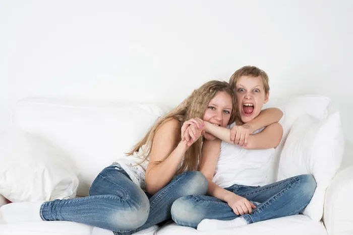 Framed Print : Girl biting a boy's hand Framed Print : Girl biting a boy's hand