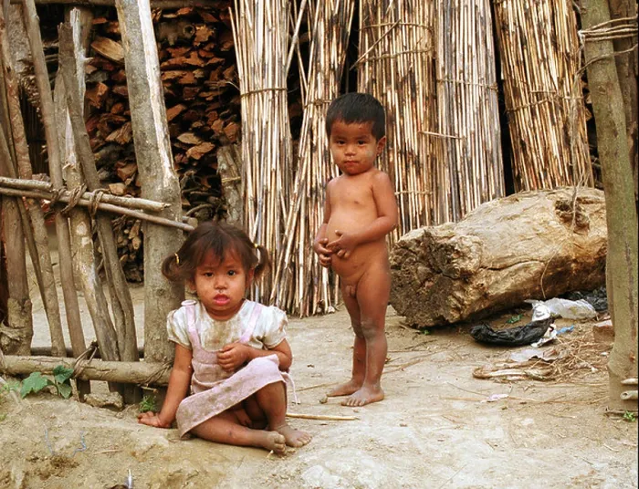 Framed Print : Girl and boy in front of a wood cabin in Nepal Framed Print : Girl and boy in front of a wood cabin in Nepal