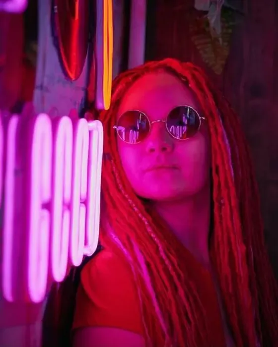 Framed Print : Girl in neon lights, beautiful woman in sunglasses, with pink hair, with dreadlocks pigtails