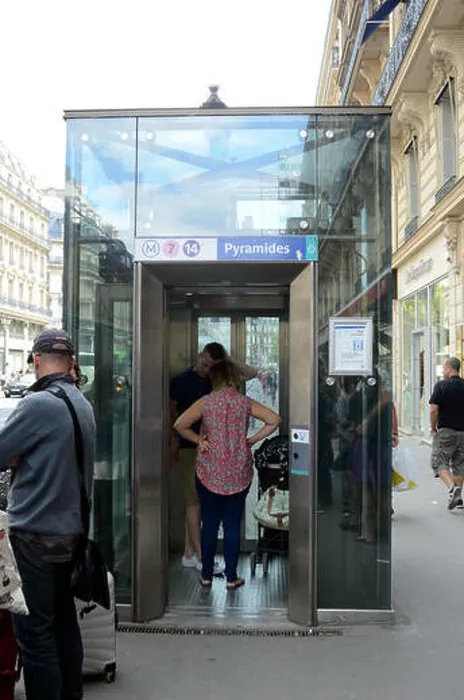 Framed Print : A glass elevator leads from the street down into the Paris Metro Framed Print : A glass elevator leads from the street down into the Paris Metro