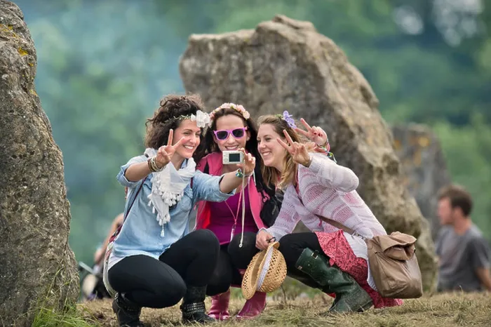 Framed Print : Glastonbury Festival 2013 UK A group of three girls record the moment at the stone circle Framed Print : Glastonbury Festival 2013 UK A group of three girls record the moment at the stone circle