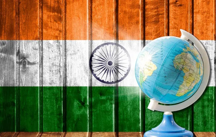 Framed Print : Globe with a world map on a wooden background with the image of the flag of India