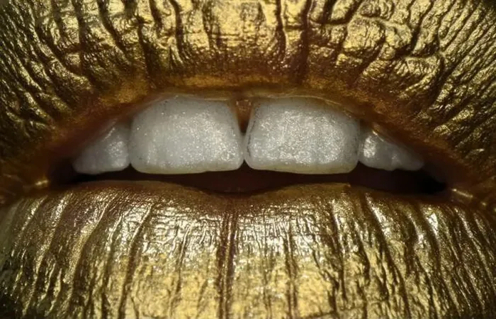 Framed Print : Golden lips macro close up. Lip icon with golden glitter effect