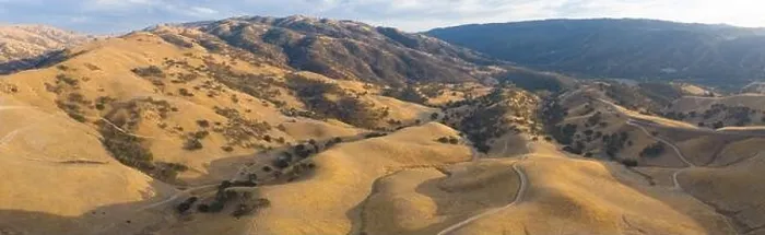 Framed Print : Golden sunlight shines on the rolling hills in Northern California. These beautiful, eroded hills turn green once winter brings seasonal rain Framed Print : Golden sunlight shines on the rolling hills in Northern California. These beautiful, eroded hills turn green once winter brings seasonal rain
