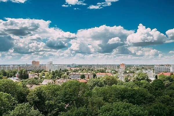 Gomel, Belarus. Cityscape And Architecture. Top Aerial View Of Ferris Wheel Among Green Trees Crowns And Old Soviet Residential And Administrative Bui