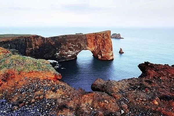 Gorgeous landscape with unique basalt arch on Dyrholaey Nature Reserve, Iceland, Europe