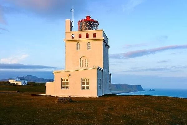 Gorgeous landscape with white lighthouse at Cape Dyrholaey, located on south coast of Atlantic ocean in Iceland