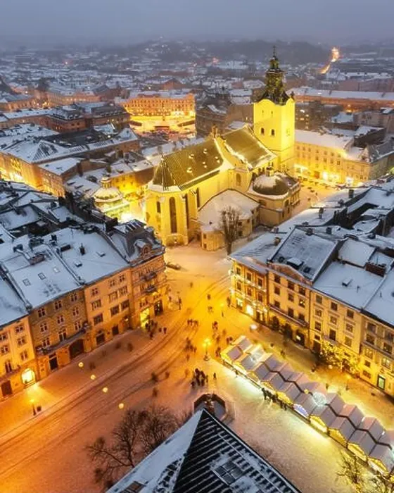 Framed Print : Gorgeus cityscape of winter Lviv city with roofs covered by snow from top of town hall, Ukraine, Europe. Latin Cathedral glowing by city lights Framed Print : Gorgeus cityscape of winter Lviv city with roofs covered by snow from top of town hall, Ukraine, Europe. Latin Cathedral glowing by city lights