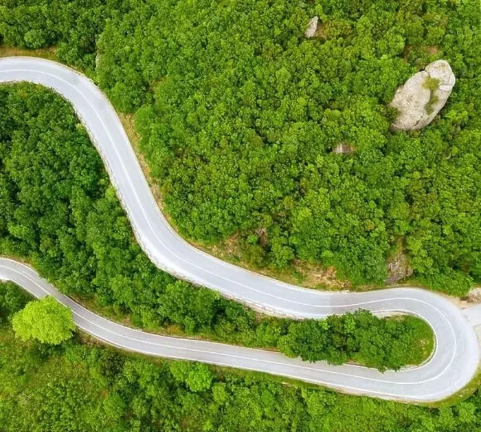 Framed Print : A gracefully curved road cuts through a vibrant Framed Print : A gracefully curved road cuts through a vibrant