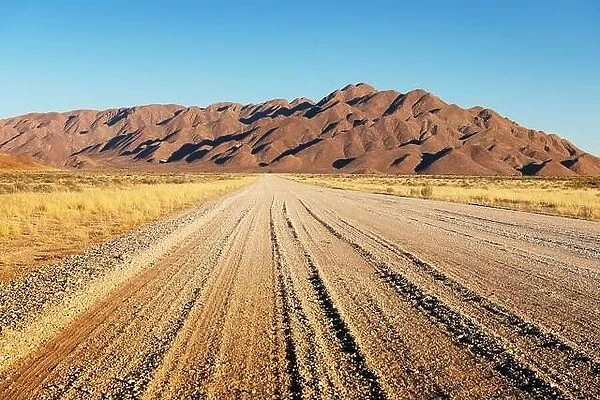 Gravel road and beautiful landscape with sunset sky in Namibia, Africa