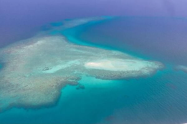 Great Barrier Reef Blue Sea view. Beautiful aqua turquoise waters, with coral reef patterns in the ocean. Aerial view, seascape