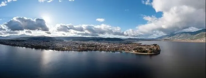 Framed Print : Greece, Ioannina city. Aerial panoramic drone view of Giannena and Lake Pamvotis, cloudy blue sky. Epirus Framed Print : Greece, Ioannina city. Aerial panoramic drone view of Giannena and Lake Pamvotis, cloudy blue sky. Epirus