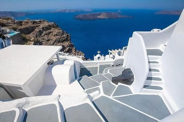 Greek island of Santorini. Amazing travel panorama, white houses, stairs and flowers on the streets. Idyllic summer vacation, urban landscape, tourism