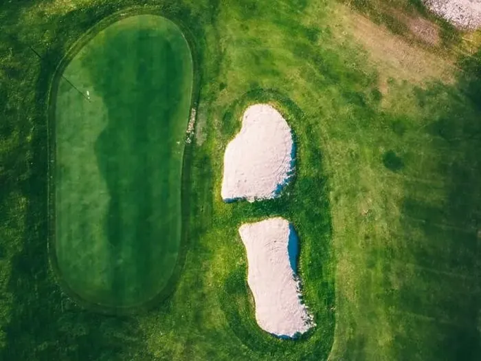 Framed Print : The green of a golf course is prominently displayed from above