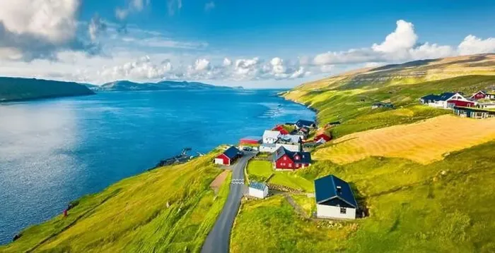 Framed Print : Green summer view from flying droneof Kirkjubour village with Hestur Island on background Framed Print : Green summer view from flying droneof Kirkjubour village with Hestur Island on background