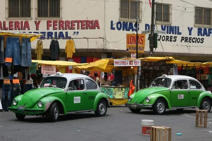 Framed Print : Two green and white beetle taxis driving through a market in Mexico City, Mexico, South America Framed Print : Two green and white beetle taxis driving through a market in Mexico City, Mexico, South America