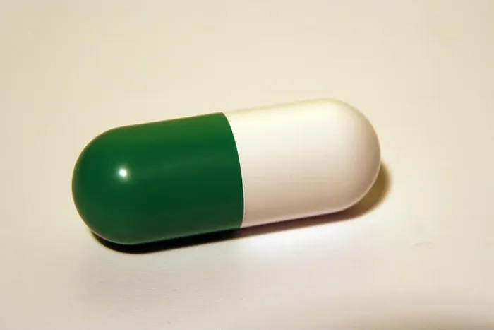 Framed Print : Green and white medical pill. Antibiotic capsule Framed Print : Green and white medical pill. Antibiotic capsule