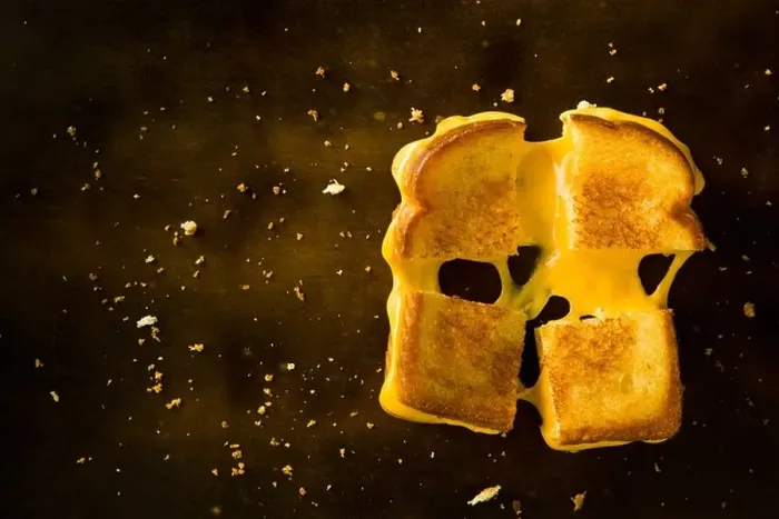 Framed Print : A Grilled Cheese Sandwich cut in four squares pulling the cheese on a wood table Framed Print : A Grilled Cheese Sandwich cut in four squares pulling the cheese on a wood table