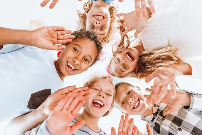 Framed Print : Group of happy children waving at the camera Framed Print : Group of happy children waving at the camera