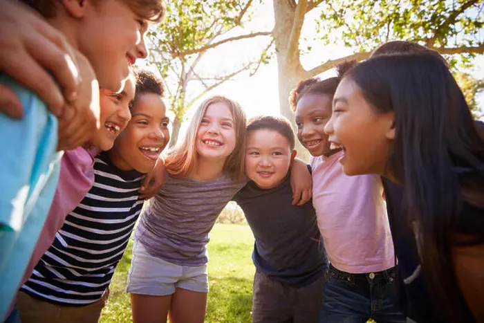 Framed Print : Group of schoolchildren embrace standing in a circle Framed Print : Group of schoolchildren embrace standing in a circle