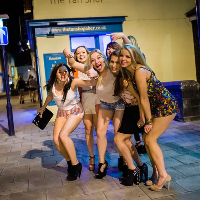 Framed Print : A Group of young girls women wearing shorts out on the streets celebrating and partying on Saturday night Framed Print : A Group of young girls women wearing shorts out on the streets celebrating and partying on Saturday night