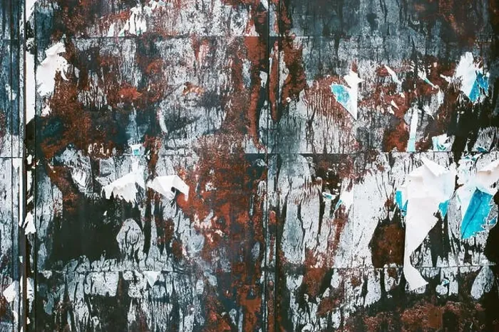 Framed Print : Grunge texture of torn poster paper scraps on the wall Framed Print : Grunge texture of torn poster paper scraps on the wall