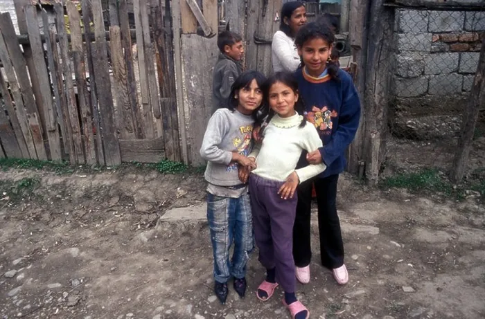 Framed Print : Five Gypsy children pose in front of a wooden fence in their village of Soard [Transylvania], Romania