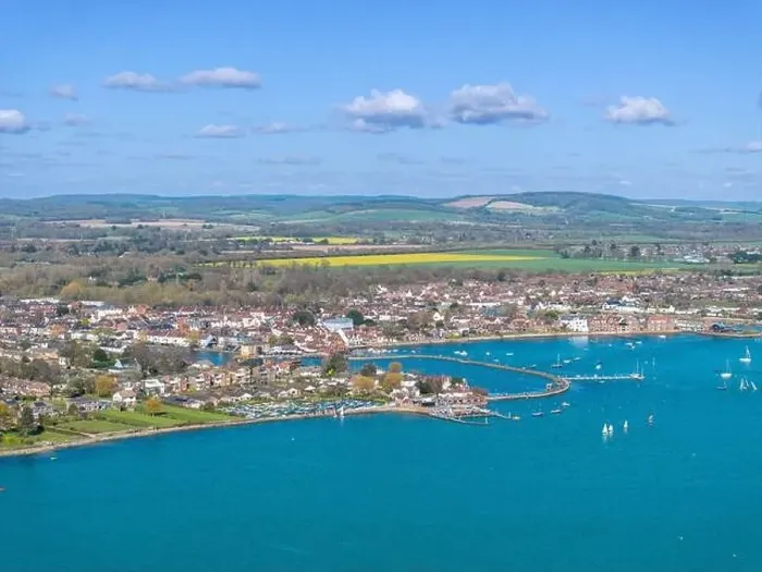 Framed Print : Hampshire town of Emsworth from above. View looking East along the coastline. Farmland and hills beyond the town Framed Print : Hampshire town of Emsworth from above. View looking East along the coastline. Farmland and hills beyond the town