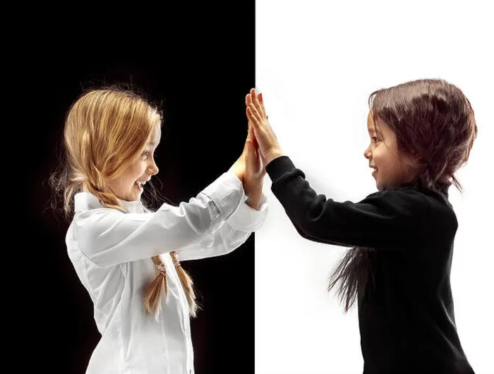 Framed Print : Hand shake and high five. The portrait of two happy holding hands girls on a white and black studio background Framed Print : Hand shake and high five. The portrait of two happy holding hands girls on a white and black studio background