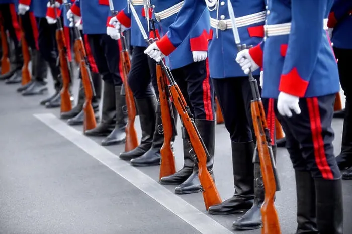 Framed Print : Detail with the hand of a soldier on a bayonet rifle in rest position during a military parade