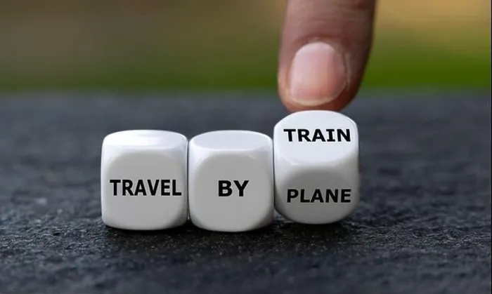Framed Print : Hand turns dice and changes the expression travel by plane to travel by train Framed Print : Hand turns dice and changes the expression travel by plane to travel by train