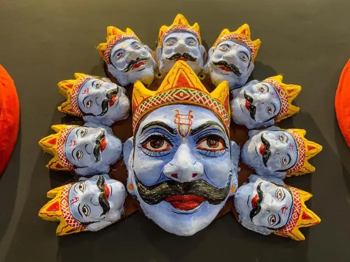 Framed Print : Handmade colorful tribal look of Ravan face mask souvenir hanging on plain black background. Selective focus on object Framed Print : Handmade colorful tribal look of Ravan face mask souvenir hanging on plain black background. Selective focus on object