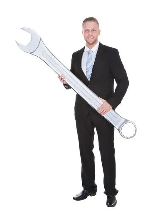 Framed Print : Handsome bearded businessman in a smart suit holding a large metal spanner in his hands conceptual of problem solving Framed Print : Handsome bearded businessman in a smart suit holding a large metal spanner in his hands conceptual of problem solving