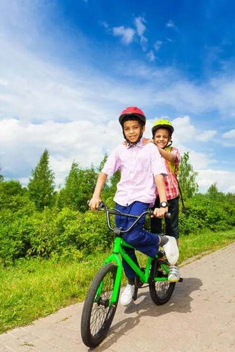 Framed Print : Two happy boys riding same bike both standing Framed Print : Two happy boys riding same bike both standing
