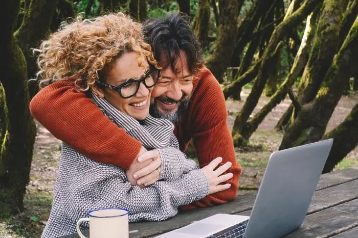Framed Print : Happy couple in love and friendship enjoy video call on laptop together hugging and smiling. Nature outdoors forest background Framed Print : Happy couple in love and friendship enjoy video call on laptop together hugging and smiling. Nature outdoors forest background