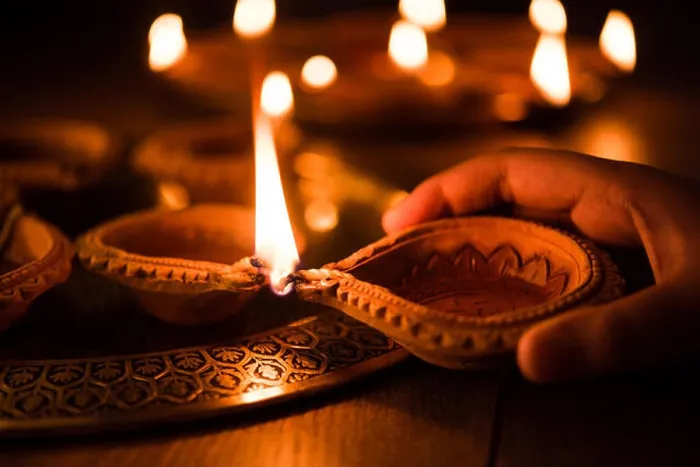 Framed Print : Happy diwali - Hand holding or lighting or arranging diwali diya or clay lamp in brass plate, selective focus Framed Print : Happy diwali - Hand holding or lighting or arranging diwali diya or clay lamp in brass plate, selective focus