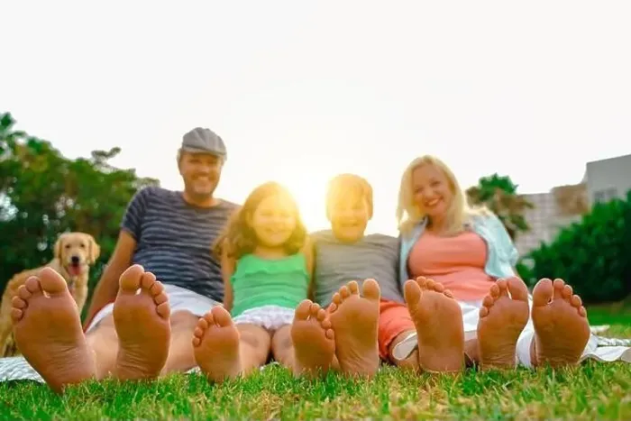 Framed Print : Happy family lying outdoors in the park. Family relaxing on the grass. Close up of feet - Image Framed Print : Happy family lying outdoors in the park. Family relaxing on the grass. Close up of feet - Image