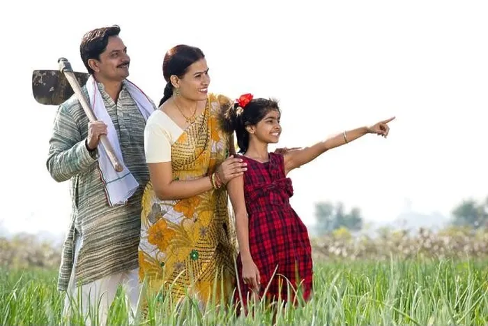 Framed Print : Happy Indian family in agricultural field looking away Framed Print : Happy Indian family in agricultural field looking away
