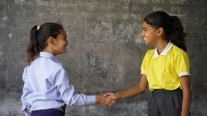 Framed Print : Happy Indian school girl child standing in front of black chalkboard background. Education Concept or Back to School